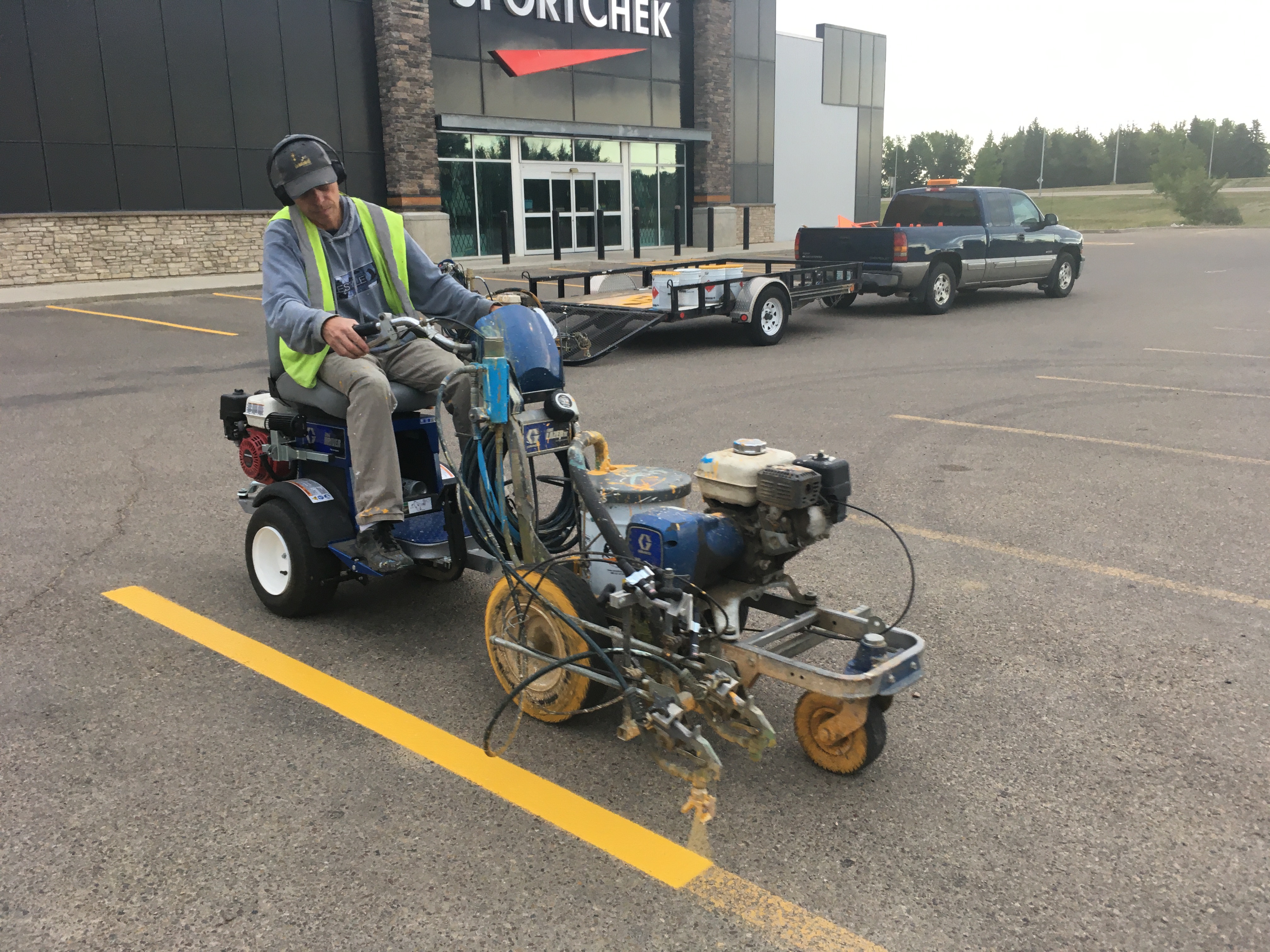 Line painting in a parking lot.